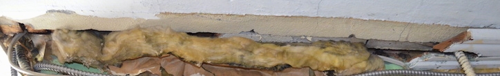 Fiberglass exposed and shoved in a wall