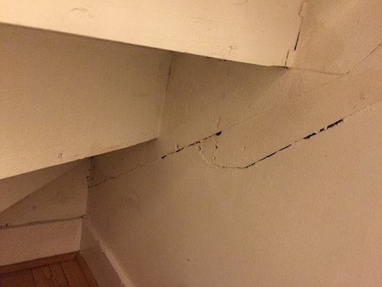 a crack in the wall inside of a bedroom closet