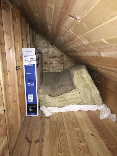 Two large pieces of fiberglass in a finished off attic crawl space just laying on the floor