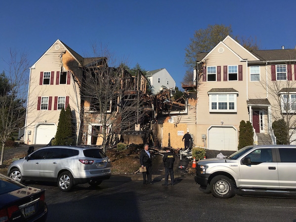 A row of townhomes with the middle three burnt down by a fire.