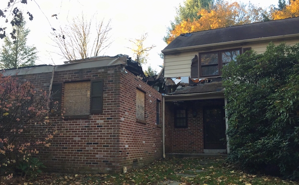 A brick house that burned down with the roof burned off.