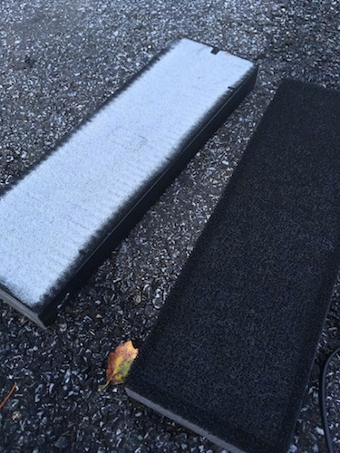 A clean black filter cartridge next to a dirty white one. It pulled white matter out of the air.