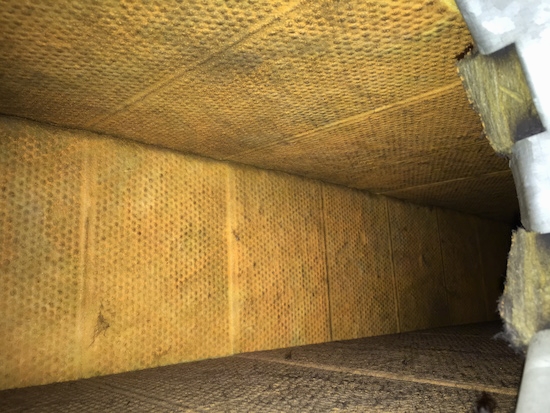 A fiberglass lined duct with a yellow cloth-like lining