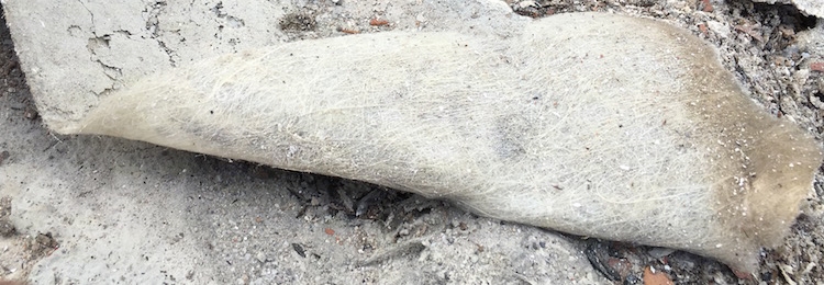 A sheet of fiberglass the shape of a roof shingle folded over on its side.