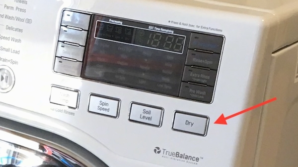 Close up - the buttons on a ventless dryer with a red arrow pointing to the dry button.