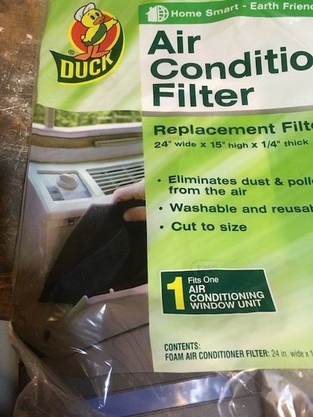 A clear and green plastic Duck brand Air Conditioning Replacement Filter. The package reads  Air Conditioner Filter Replacement Filter 24 wide x 15 high x 1/4 thick, Eliminates dust and pollen from the air, Washable and reusable, Cut to Size. 1 Fits One Air Conditioning Window Unit.