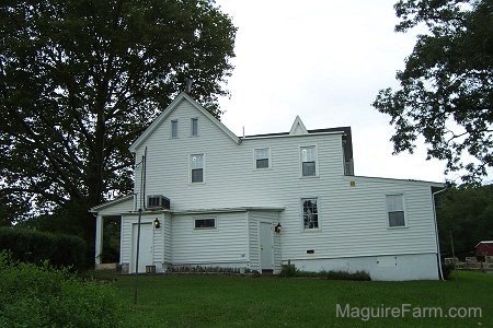 The back view of a white farm house