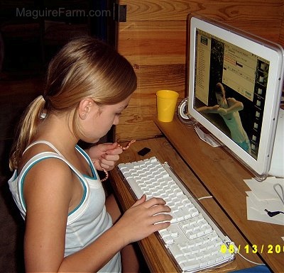 A blonde-haired girl in a white shirt is holding a snake and typing a message on AOL Instant Messenger